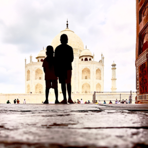 Caleb and Micah silhouetted in front of the Taj Mahal early in the morning, on a family trip to India.
