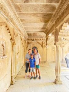 Kelly and her two boys inside City Palace Udaipur, India family travel with kids.