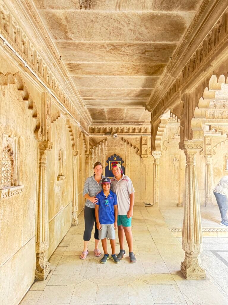 Kelly and her two boys inside City Palace Udaipur, India family travel with kids.