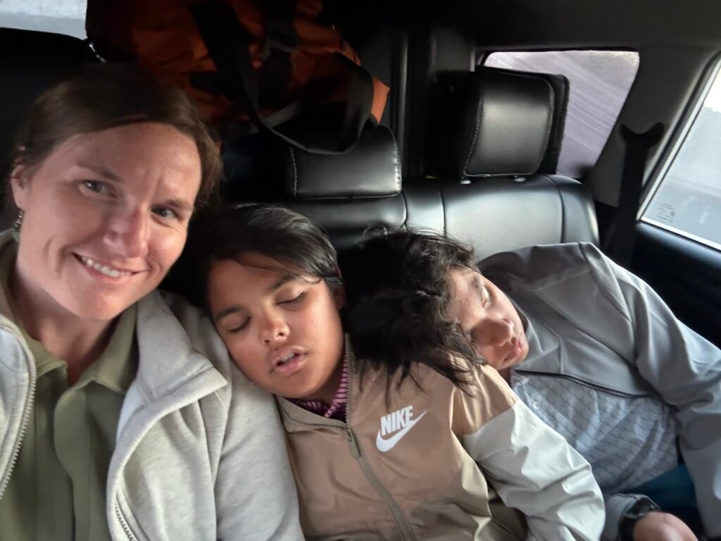 kids asleep in car after landing in India, india family travel guide