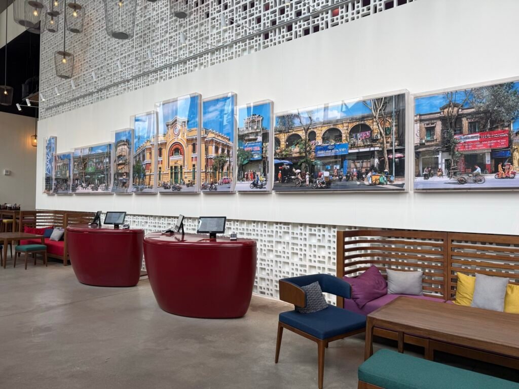 Wink Hai Phong lobby with red check-in pods and large photos of Hai Phong